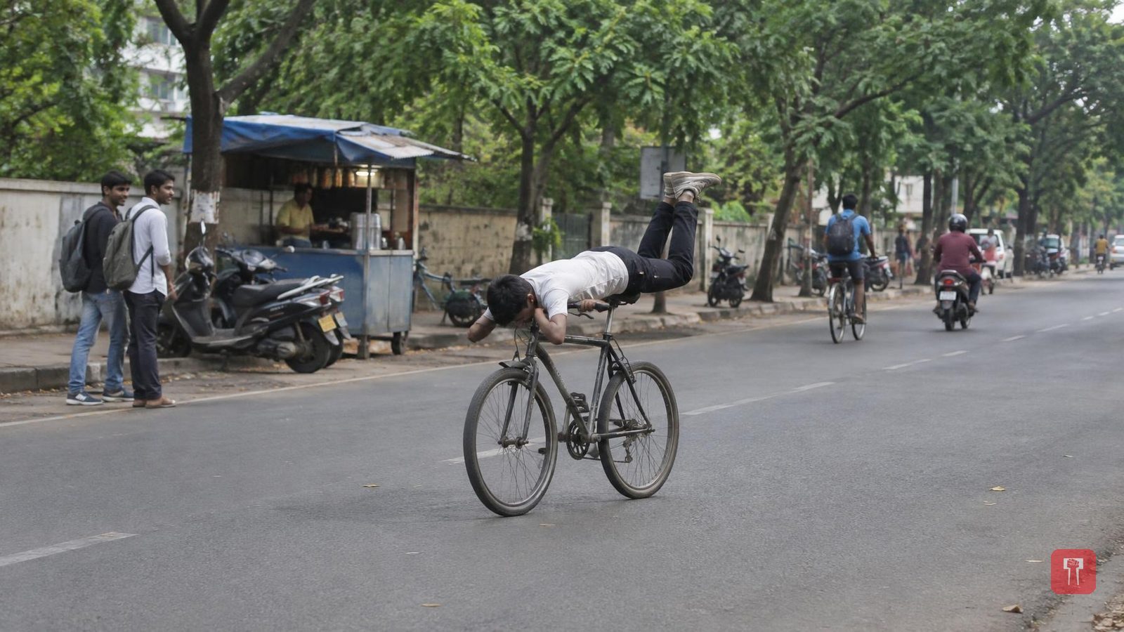 Cyclist's upside-down stunt on a moving bicycle goes viral on social media